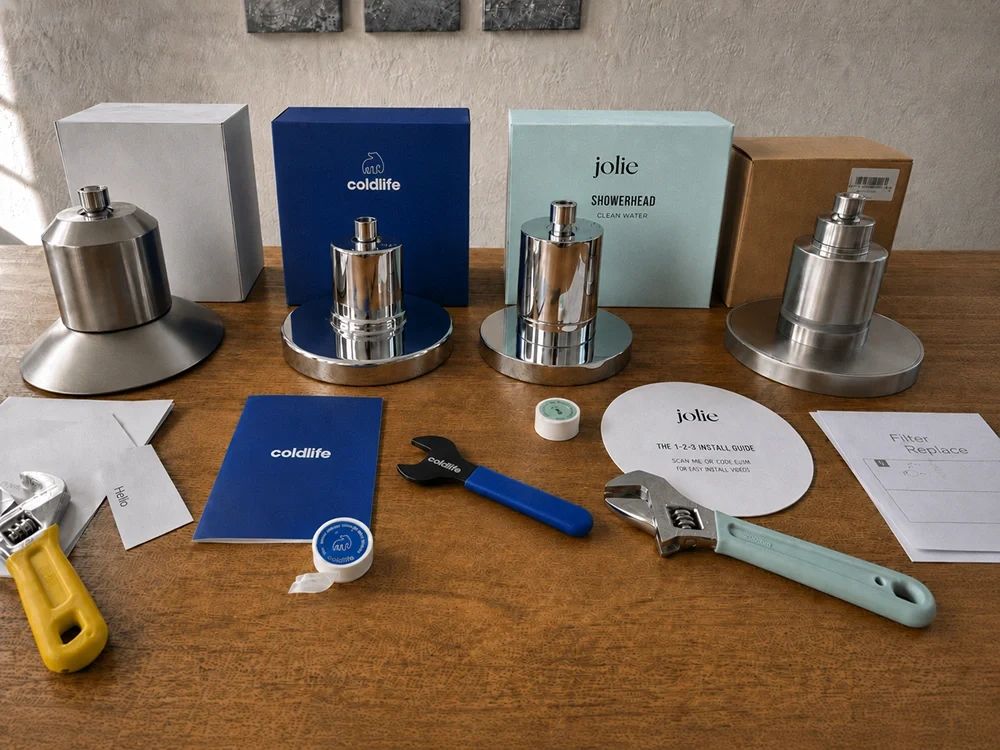 All seven filtered showerheads unboxed side by side on the testing table